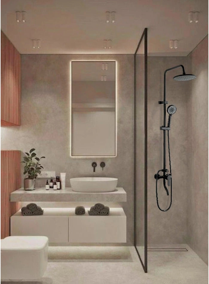 Black overhead and handheld shower set in a warm stone bathroom