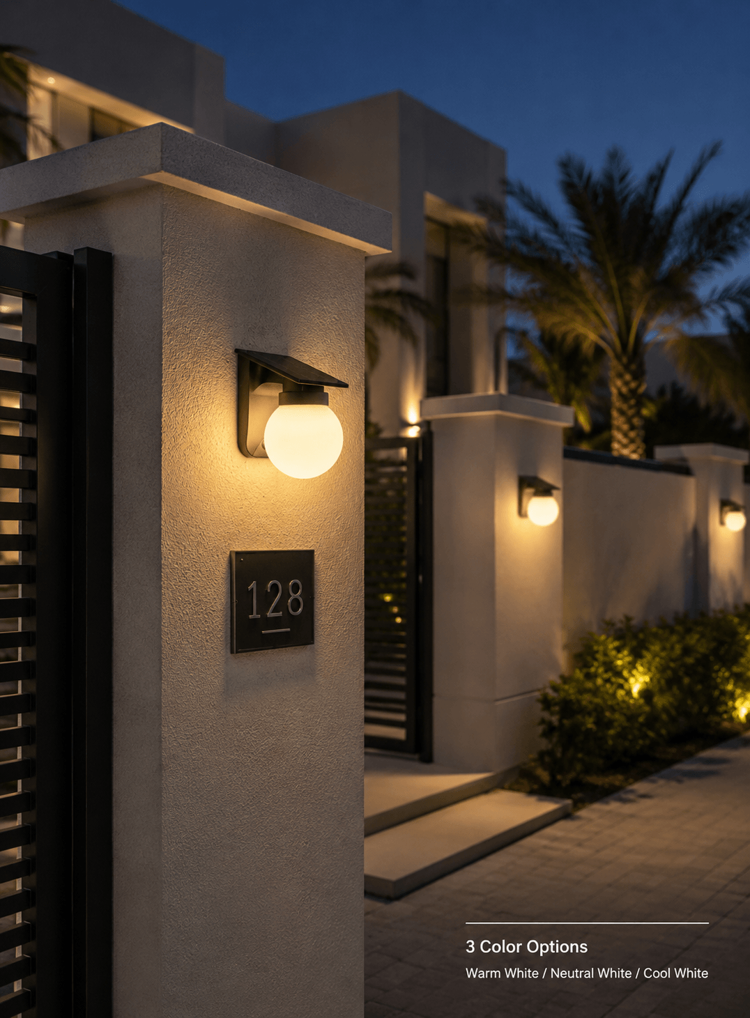 Solar wall light installed on modern villa entrance gate pillars with warm outdoor lighting for garden wall and yard decoration in Kuwait.