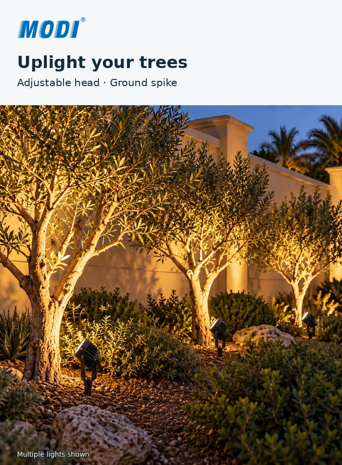 MODI 0205R garden spike lights positioned near ornamental trees with lamp heads aimed upwards at the trunks