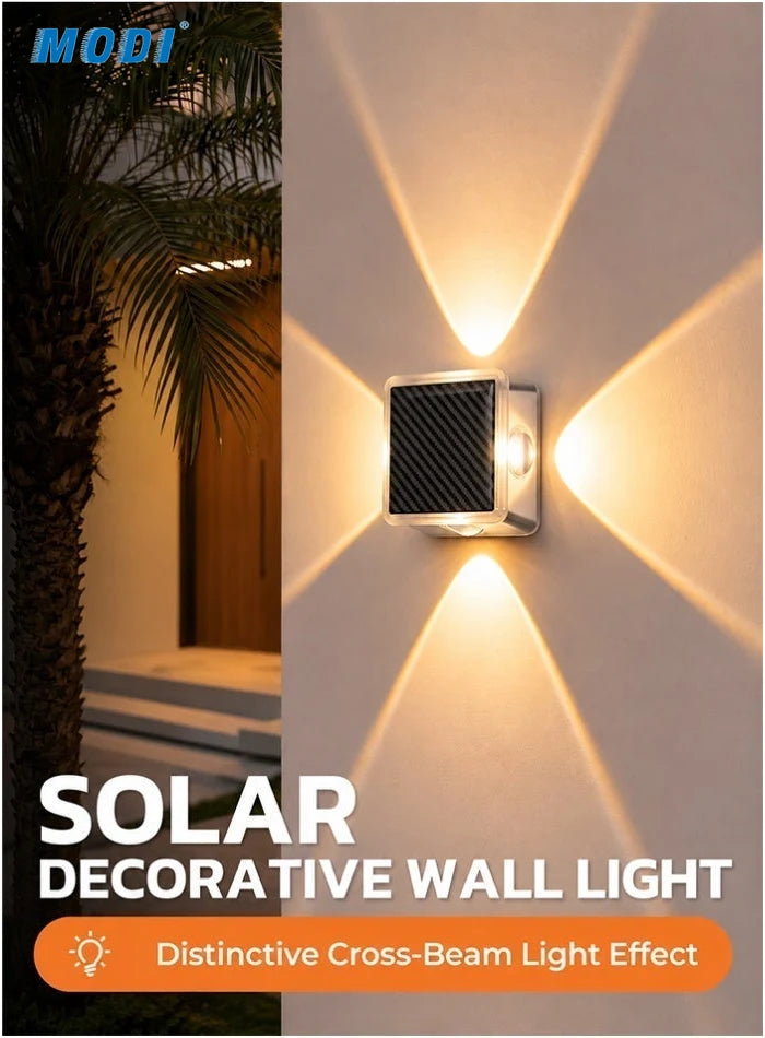 MODI solar wall light projecting four warm X-shaped beams on a villa wall